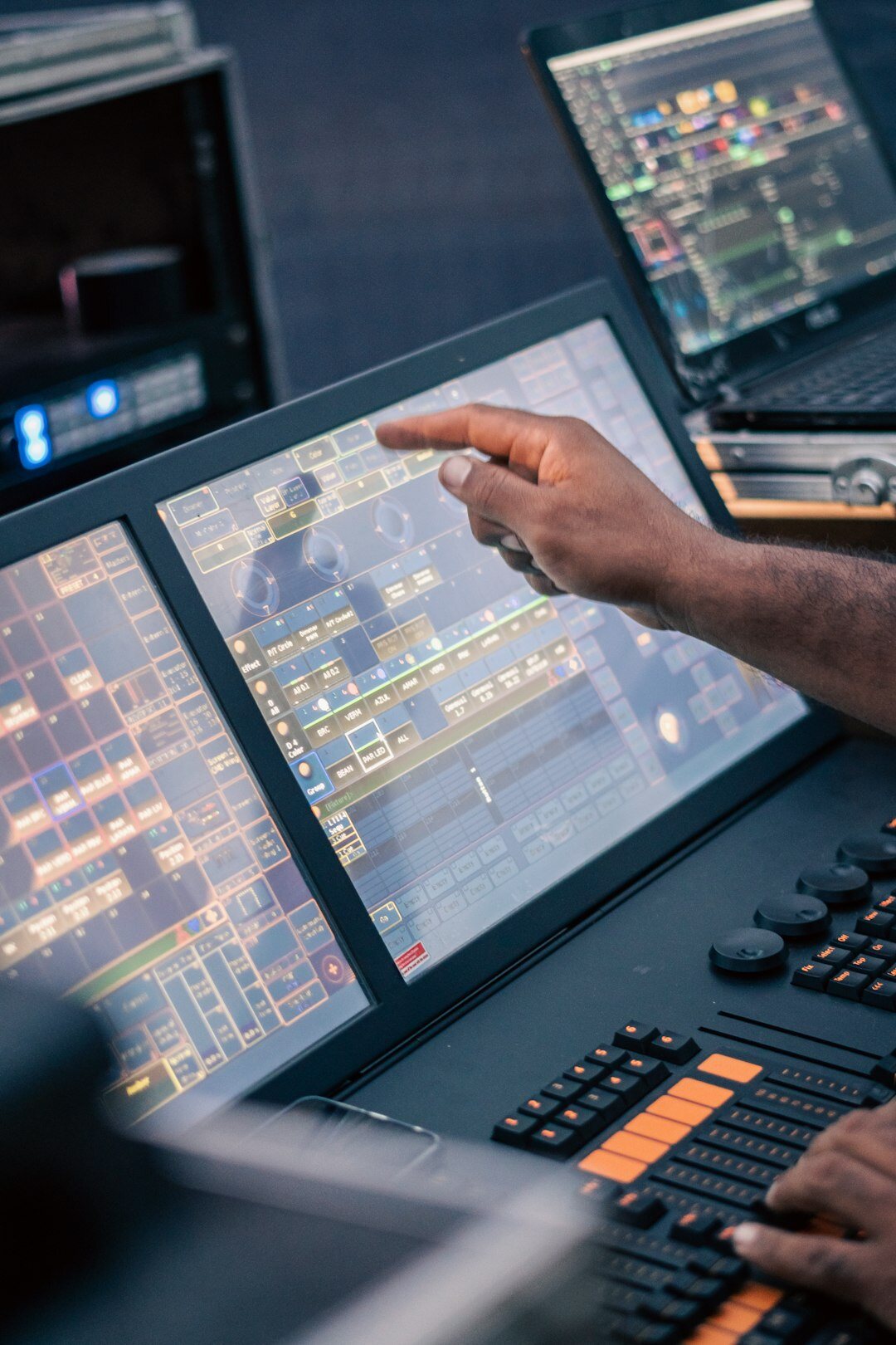Technician operating a video switcher with multiple screens